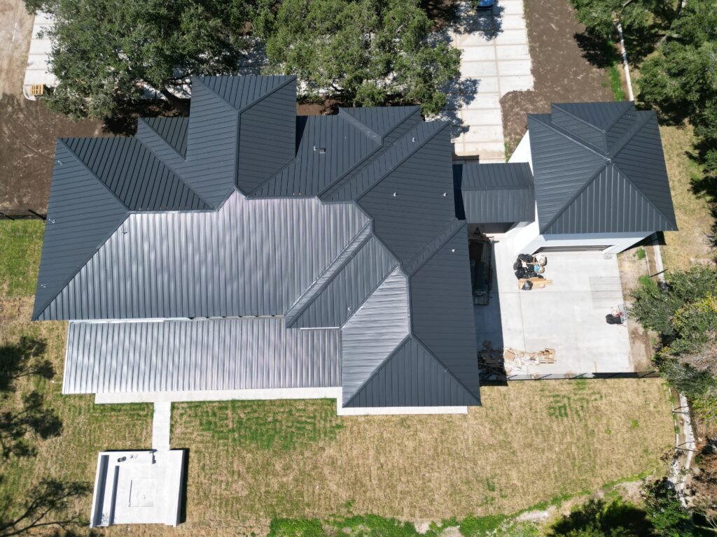 Overhead view of a home with a gray standing seam metal roof