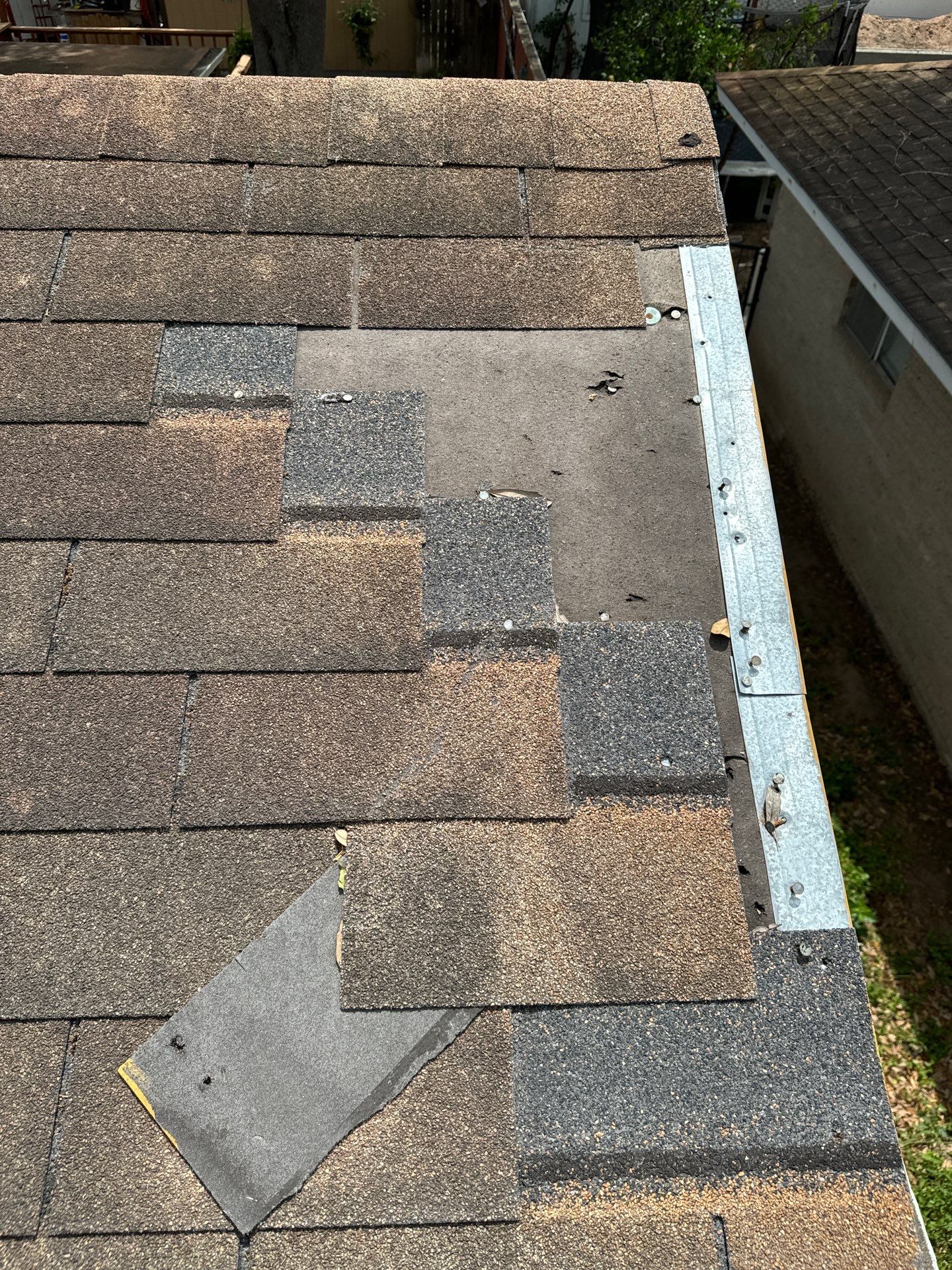 Wind Damage Roof Repair McAllen lifted shingles close-up