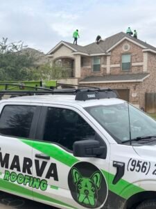 Marva Roofing truck in front of a two-story home with crew members working on the shingle roof.